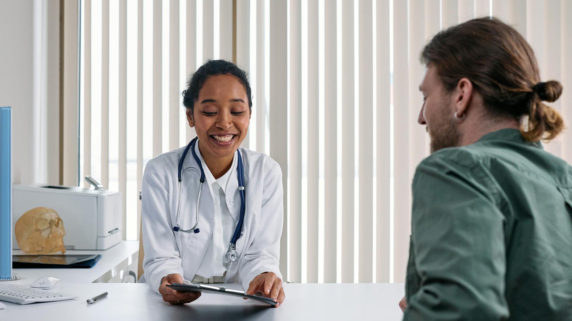 Doctor consulting with a patient in a caring clinical setting